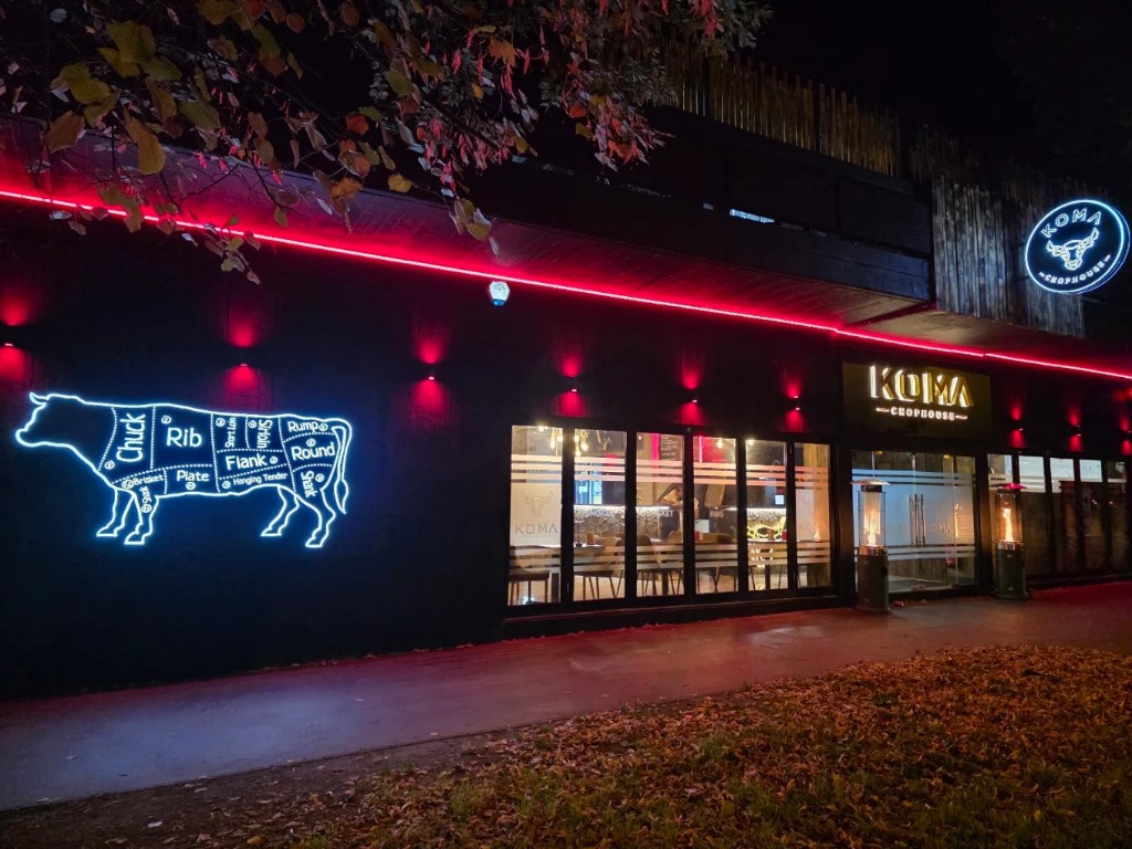 Koma Chophouse exterior at night with neon signage, Purley