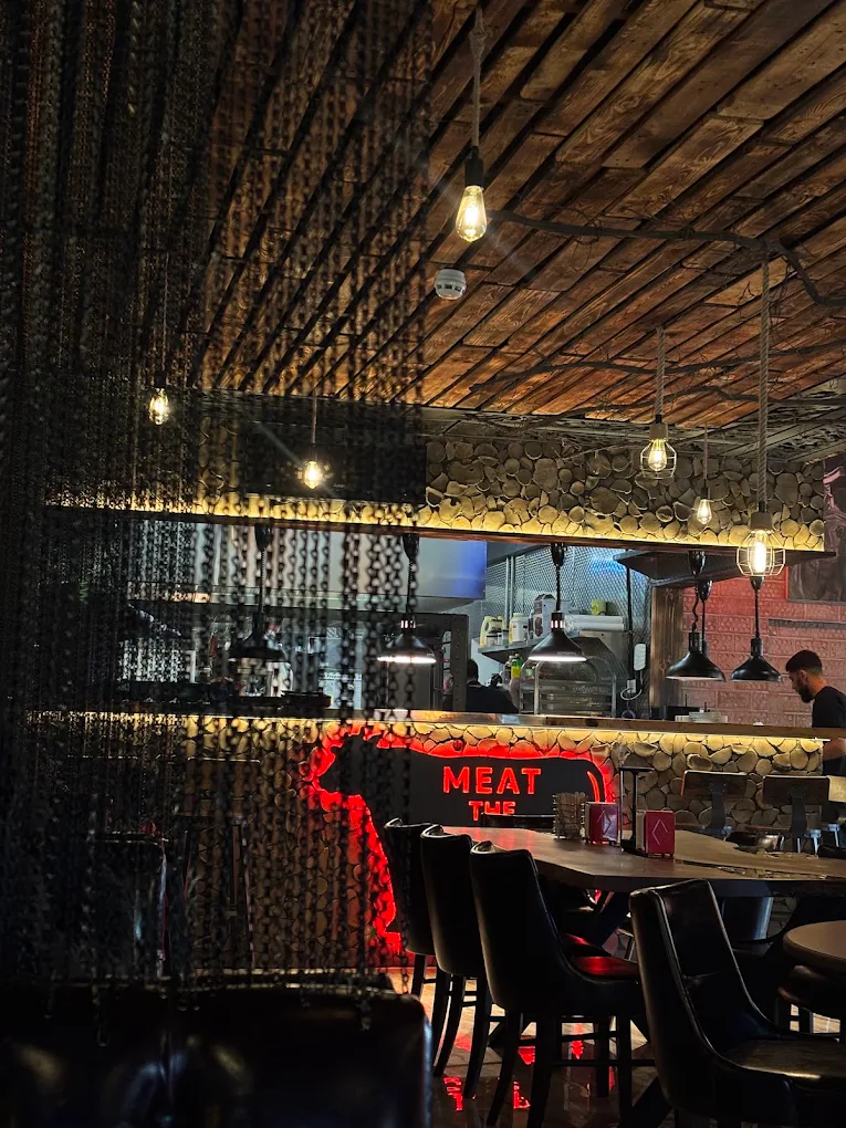 Koma Chophouse dining room with neon cow artwork